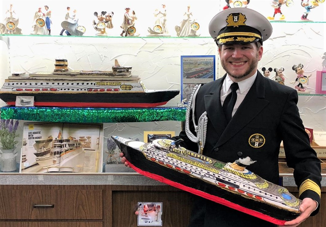 Pictured, Commodore Justin Higner is holding the `Oceanic IV.` 